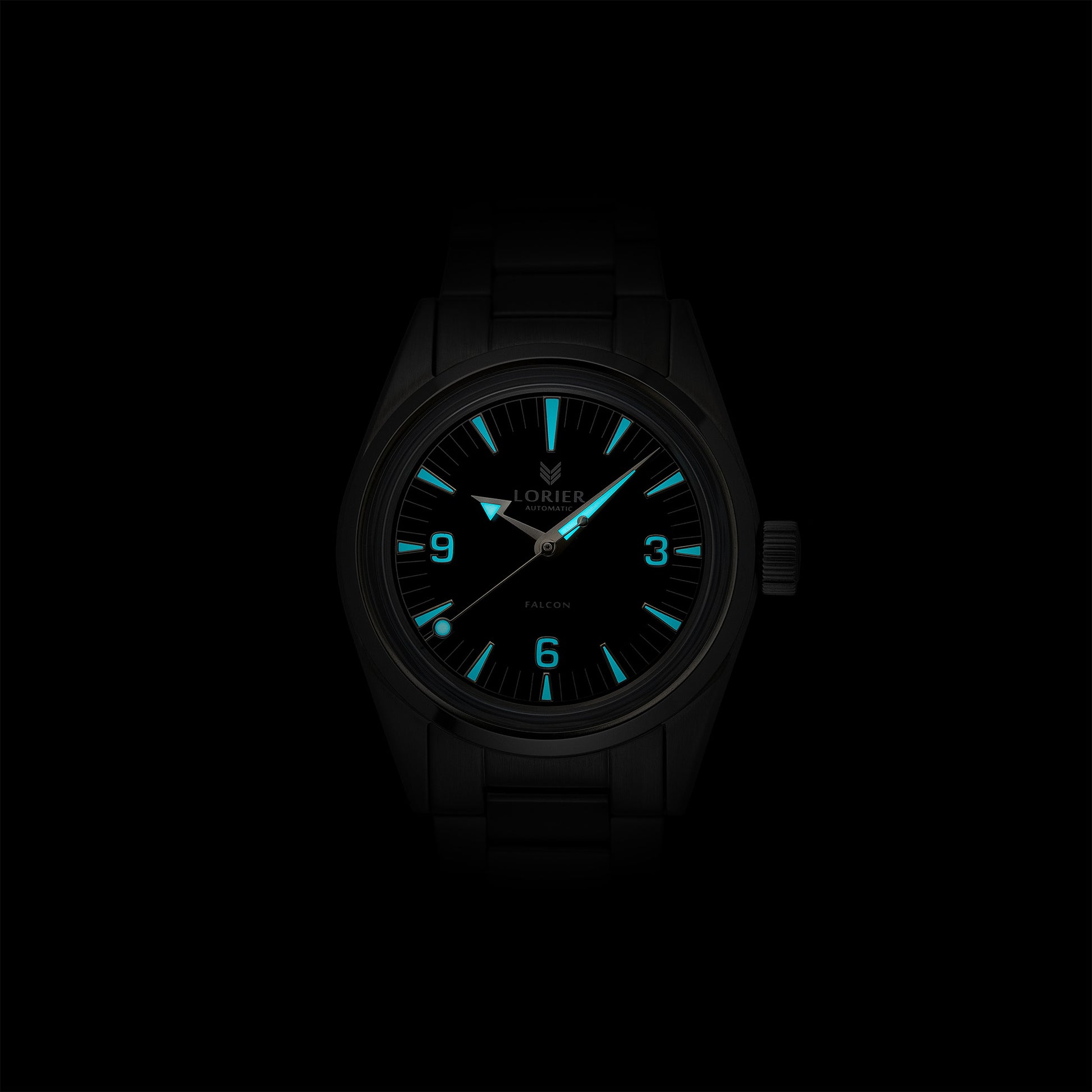 Lorier Falcon automatic watch in darkness showing Superluminova lume on Arabic numerals, baton hour markers, and handset glowing blue-green against black background.