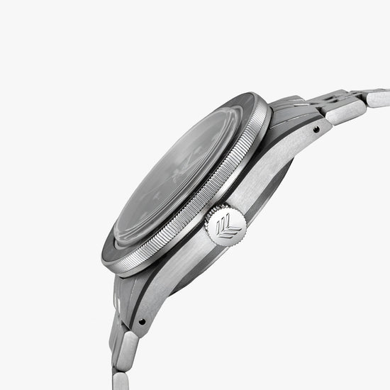 Lorier Hyperion GMT automatic watch side profile on white background, brushed steel case with knurled rotating bezel, screw-down engraved Lorier crown, and five-link bracelet.