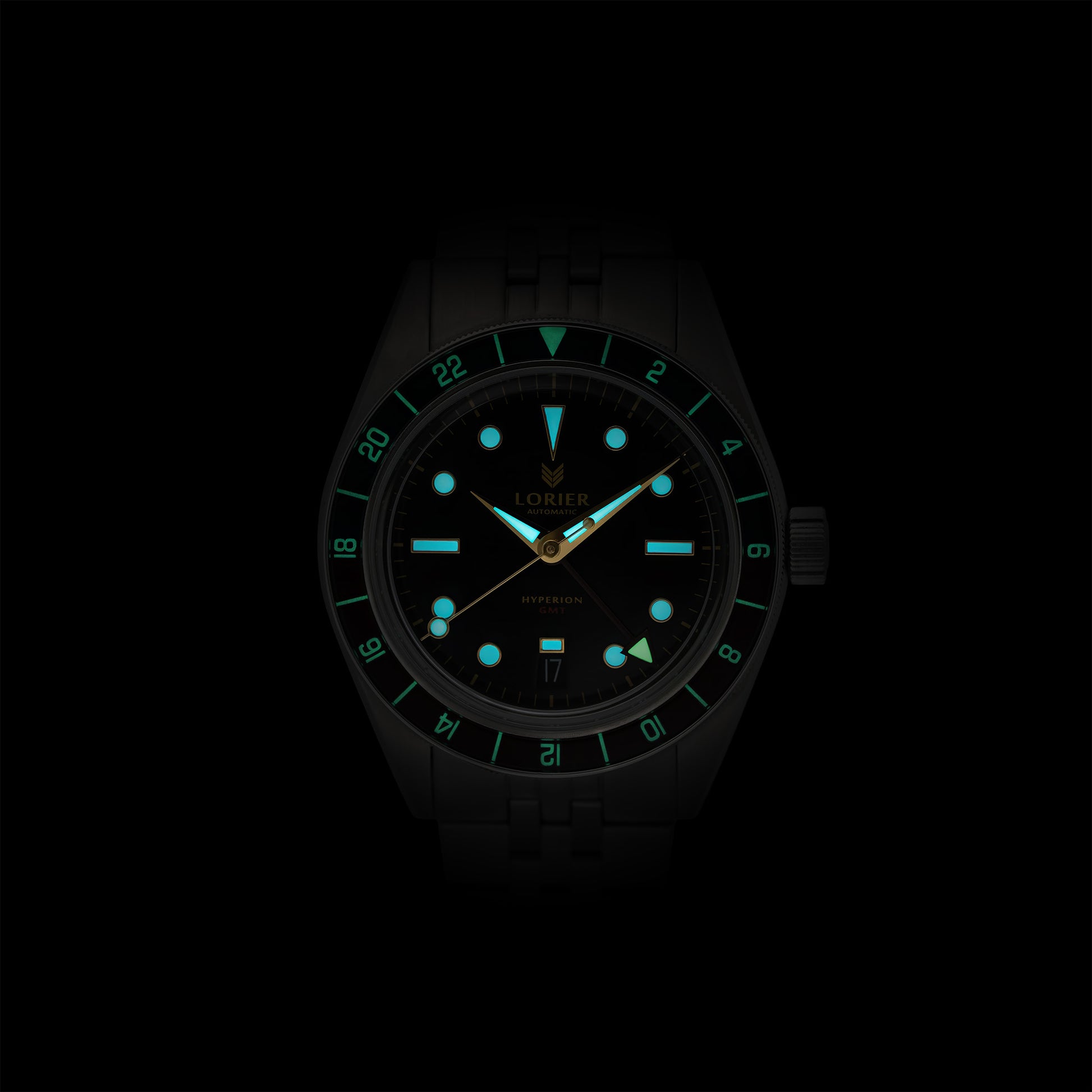 Lorier Hyperion GMT automatic watch in darkness showing Superluminova lume on hour markers, handset, and GMT bezel numerals glowing blue-green against black background.